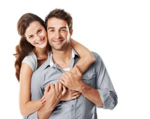 A playful young woman embracing her boyfriend from behind - Copyspace